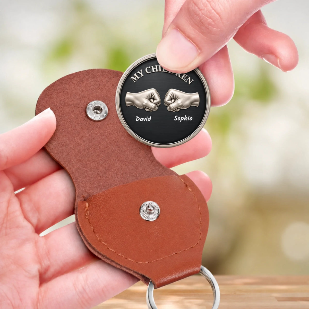 Personalized My Children pocket hug coin keychain held in hand with brown leather pouch – meaningful siblings gift from Mom or Dad